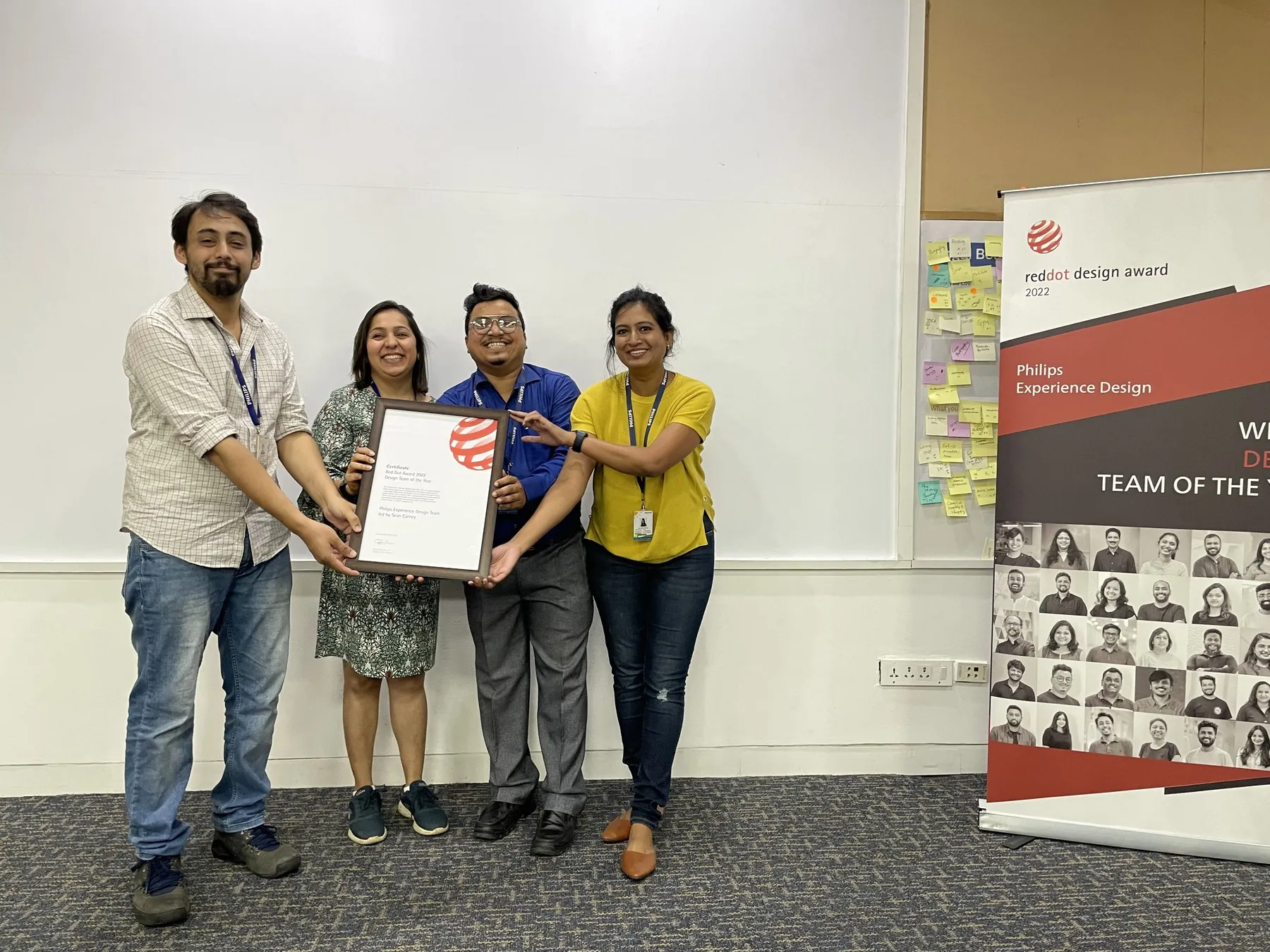 Shubham Gupta and colleagues holding a Red Dot Design Team of the Year certificate.
