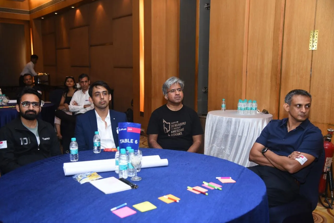 Shubham Gupta seated with industry participants during a workshop.